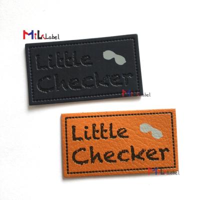 China Viable wholesale custom debossed and silk screen printing branded patches leather jeans leather label iron on leather label for sale