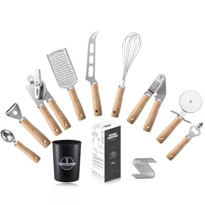 China Stocked 9 /set Stainless Steel Kitchenware Utensils with Wooden Handle Peeler Egg Beater Garlic Press Spoon Bottle Opener Pizza Cutter for sale