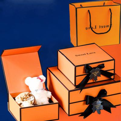 China 2022 Customs Handmade Luxury Paper Gift Box Packaging Orange Bow-knot Square Small Folding Box For Apparel Packaging for sale