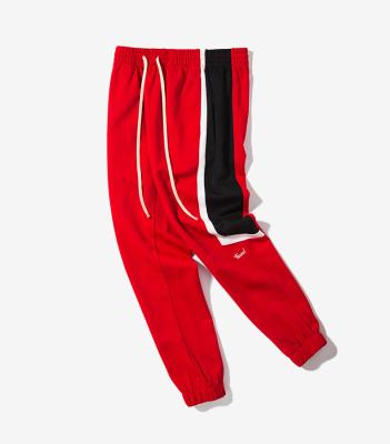 China 2020 high quality Anti-wrinkle skinny sports tracksuit sweatpants, slim fit track pants, side stripe track pants custom for sale