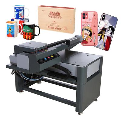 China Hotels A1 UV Printer Phone Case Mug Wine Box Printing 6090 UV Flatbed Printer With Varnish for sale