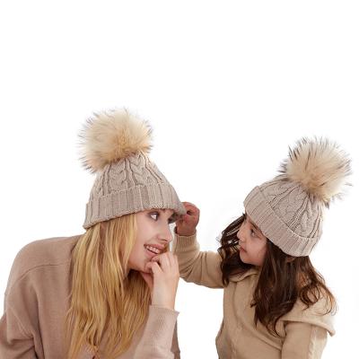 China Mommy and Me Striped Knitted Beanie Winter Wool Fur Flip Kids Hat Beanies With Cute Pom Pom for sale