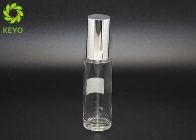 China 30ml Round Empty Glass Foundation Bottle Clear Material Made With Silver Pump for sale