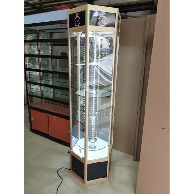 China Modern Luxury Store Floor Standing Rotating Hexagonal Glass Display Showcase for sale