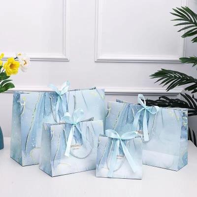 China Recyclable Customize Your Logo Square Ribbon Portable Paper Bag Gift Clothing Store Clothes Women's Tote Bag for sale