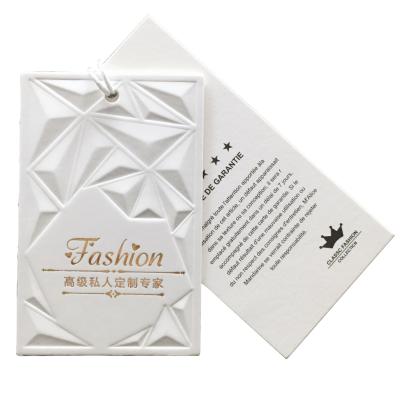 China Other Luxury Designing Custom Printing Logo To Emboss Garment Hang Tag Paper Clothing Hang Tags for sale