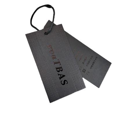 China Custom Printing Matte Black Spot Logo UV Clothing Packaging Labels Paper Gift Label for sale