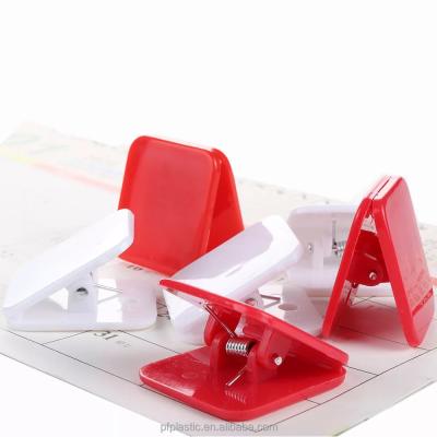 China Eco-friendly hot sale stationery red and white binder clips adjust plastic spring clips can be glued for school supplies for sale