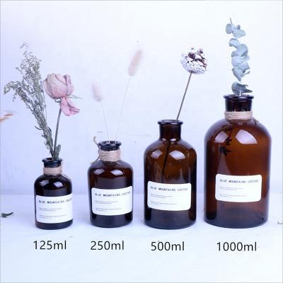 China Flower hotselling universal empty amber glass bottles for sale