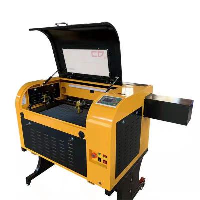 China Laser Engraving Newest 4060 Wood Laser Machine White Acrylic Stone DST Laser Leather Engraving Machine for sale