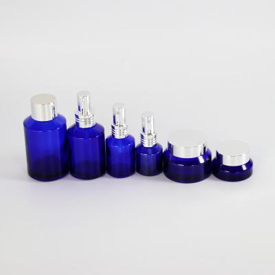 China 15ml 30ml 60ml Recyclable Empty Cobalt Blue Lotion Pump Glass Cosmetic Bottles for sale