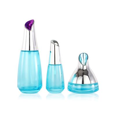 China Recyclable Cosmetic Blue Cone Shape Glass Lotion Pump Bottle And Cream Jar for sale