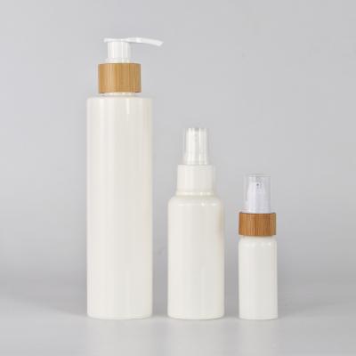 China 30ml 150ml 200ml Plastic Material Cosmetic White Bottle Skin Care Empty Package With Bamboo Lid Wholesale for sale