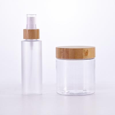 China Factory price 100ml pet cosmetic transparent frosted plastic bottle with clear bamboo pet lid 250g plastic jar with bamboo lid for sale