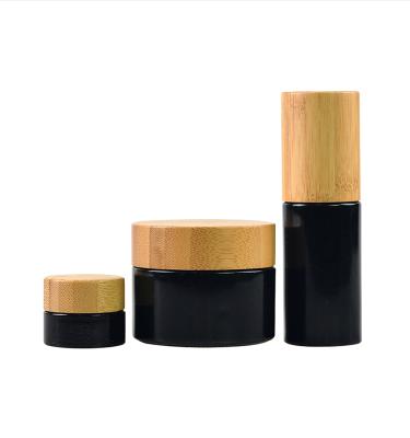 China 5ml 10ml 15ml 20ml 30ml 50ml 60ml 100ml Matte Black Red Frosted Glass Bamboo Bottle Dropper Cap Essential Oil Refillable Hot Bamboo Bottle for sale