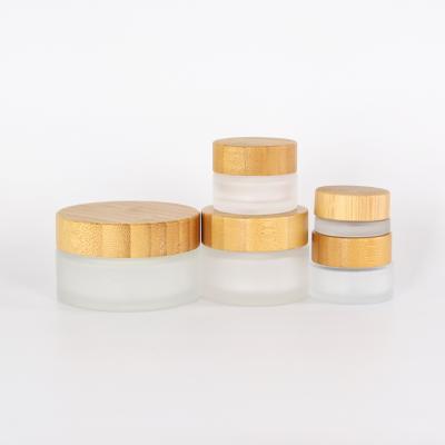 China Hot mockup 5g 15g 30g 50g 100g personal care frosted bamboo glass jars packaging with bamboo lid, cosmetic glass jar for sale