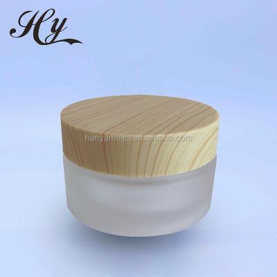 China Luxury cosmetic 30ml skin care cream factory price glass container wooden jar for sale