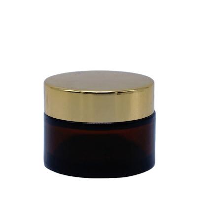 China High Demand Skincare Cream Personal Care Cosmetic 60g Amber Frosted Glass Jar Personal Care Skin Packing Round Shape Screw Cap Metallic Gold for sale