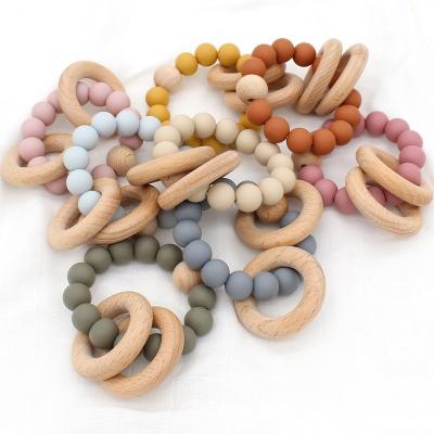 China 100%food grade Silicone Teether Baby Teething Toys Click Soft Bpa Ring Baby Silicone Novelty Free Wooden Teether Ring Bracelet. for sale