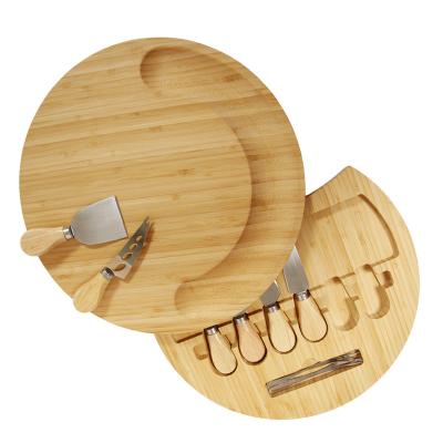 China Sustainable round charcuterie chopping utensils ceramic bowl meat cutting board luxury bamboo and wood cheese board with knife set fork for sale