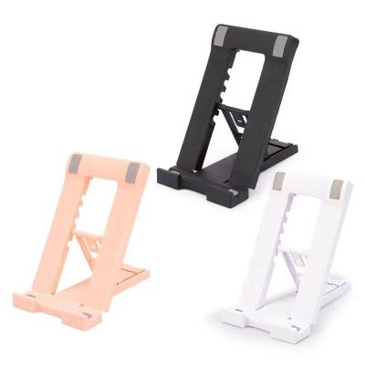 China Factory offer cheap price china factory offer cell phone stand plastic folding adjustable pocket table phone holder foldable stand for sale