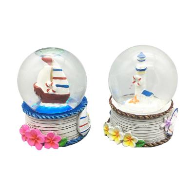 China Seaside Good Quality Wholesale Customized Boat Lighthouse Polyresin Souvenir Musical Water Globe for sale