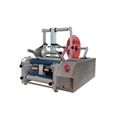 China Food Beverage Round Labeller Adhesive Sticker Label Dispenser Manual Bottle Labeling Machine for sale