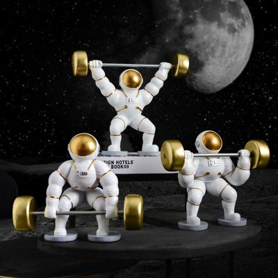 China Creative Astronaut Weightlifting Europe Resin Sculpture Figurine For Home Table Decor for sale