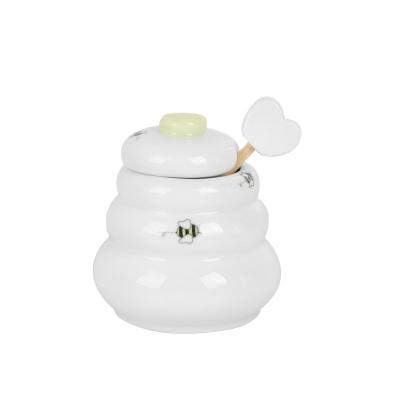 China New Design Kitchen Shape Ceramic Bee Stocked Cover Honey Jar With Small Dripper for sale