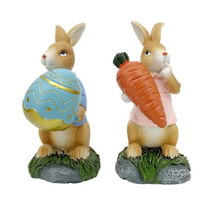 China Europe Egg Holiday Decorations Polyresin Easter Bunny Rabbits Figurines Holding Carrot for sale