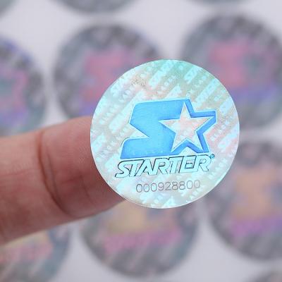 China Shiny Gold Waterproof Adhesive Waterproof Logo Printed Snapback Hologram Sticker, Custom Quality Round Cap Label Ribbon Stickers for sale