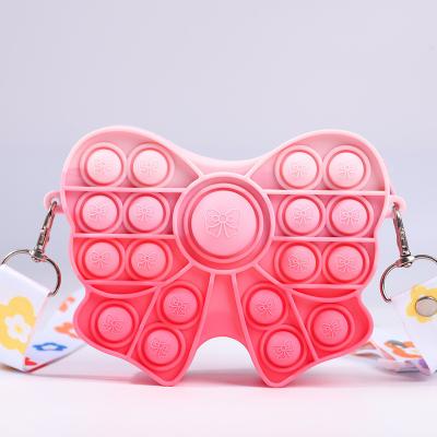 China Fidget Pop Purse Bow Girls Purse Easter Gift Sensory Fidget Toy Silicone Cross Body Kids Purse Pencil Case Makeup Bag for sale