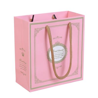 China Luxury Recycled Materials Custom Logo Rope Handle Pink Shopping Gift Hot Stamping Paper Bag For Packaging Clothes for sale