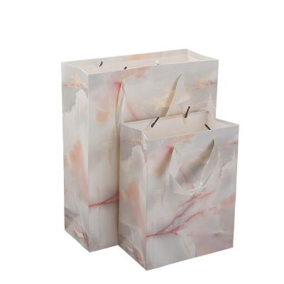 China Recycled Materials Luxury Custom Clean Logo Printed Packaging Paper Bag Shopping Kraft Paper Bag for sale