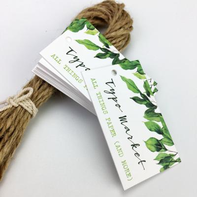 China Sustainable Matte White Stock Paper Tag Custom Embossed Paper Tag With Plastic String for sale