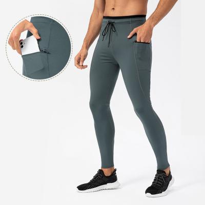 China Anti-Static Men's Fitness Basketball Training Sports Outdoor Running Pants Quick Dry Elastic Tight Pocket Zipper Gaiters High for sale