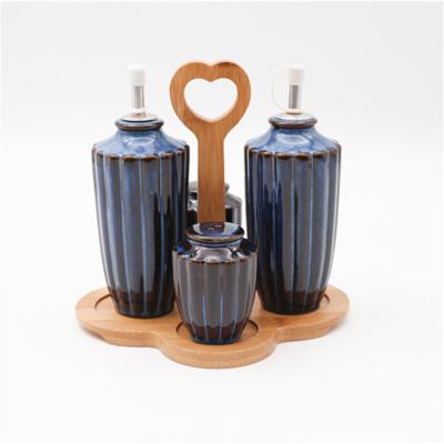 China Sustainable Unique Design Oil Vinegar Spice Jar Kitchen Care Porcelain Spice Jars Set With Wooden Rack for sale