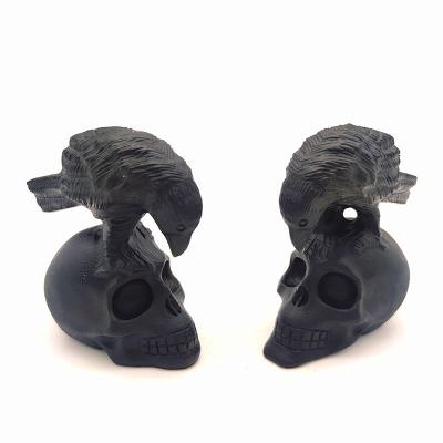 China Natural Europe Crystal Folk Crafts 100mm Healing Stone Hand Carving Black Obsidian Skull with Bird in Head for Home Decoration for sale