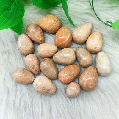 China Europe Crystal Folk Crafts 40MM Natural Orange Healing Stone Moonstone Eggs Polished Gemstone For Home Decoration for sale