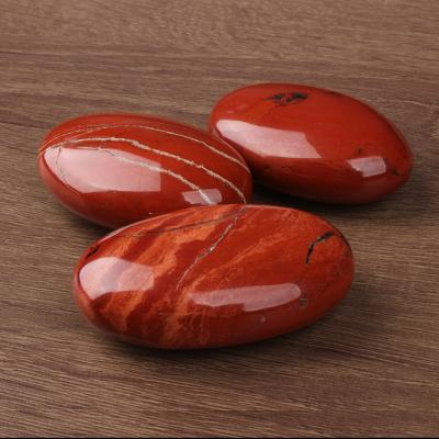 China High Quality Natural Gemstone Polished Oval Red Jasper Smooth Healing Palm Crystal Stone From Europe for sale