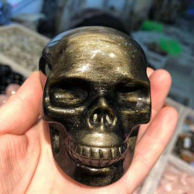 China Wholesale Natural Gold Obsidian Skulls From China Crystal Skulls Crafts Carving Gemstone for sale