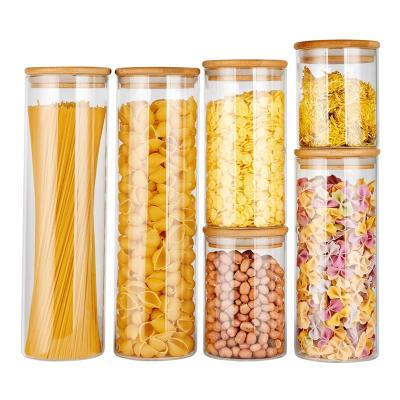 China Kitchen Storage Hot Borosilicate Freshness Preservation Vending Jar Spice Tea Glass Nut Container With Bamboo Lid for sale