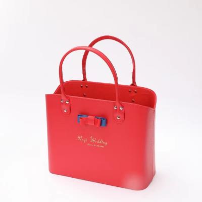 China Fashion Faux Leather Bow Style Red Packaging Portable Handle Storage Basket for sale