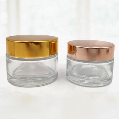 China 50ml 100ml Cosmetic Luxury Empty Face Eye Cream Glass Jar With Cap Gold Printing for sale