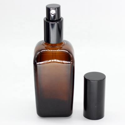 China Cosmetic Round Lotion Bottle Rectangle 50ml 100ml Amber Glass Cosmetic Packing Bottle With Black Pump Caps for sale