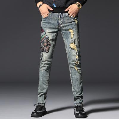 China Fashion Breathable Korean Men Brand Heads Ethnic Style Main Embroidered Jeans Spring Trend Slim Fit Distressed Ripped Pants Man for sale