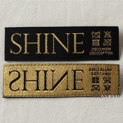 China New fashion apparel gold yarn label fish yarn custom sustainable main silk main yarn woven label for sale