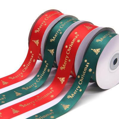 China Hot Stamping Christmas Gift Ribbon 2.5cm Green Iridescent Polyester Wholesale Ribbon Hot Stamping Gold Bronzing Printing Merry Christmas And Tree for sale