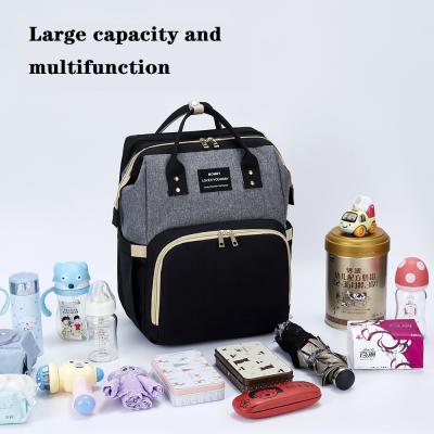 China OMASKA Night Light Fashion Diaper Backpack With Bed Mommy Baby Diaper Changing Multifunctional Waterproof Bag for sale