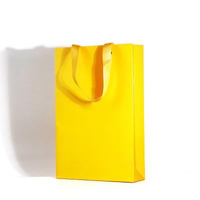 China Recycled Materials Wholesale High Quality Logo Printed Foldable Candle Packaging Gift Customized Ribbon Paper Shopping Tote Bag for sale